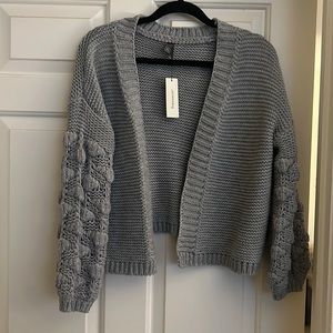 Tags still on grey knit sweater